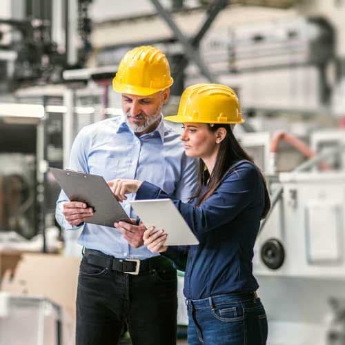 Two RT Engineers staff reviewing plans